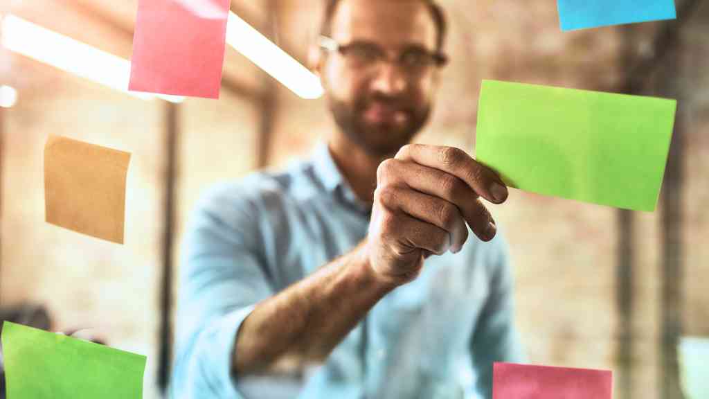 A photo of a businessman with a post-it note